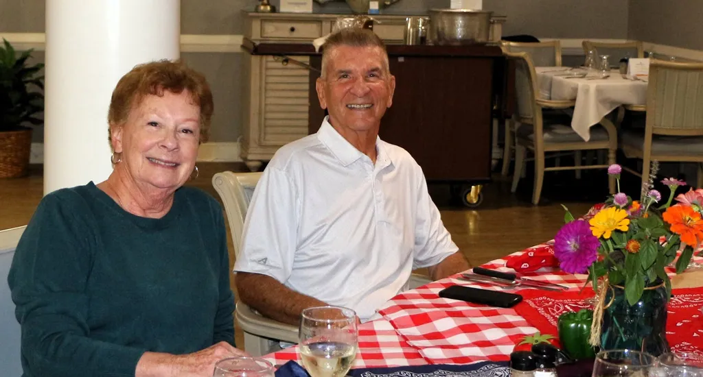 Brightwater | Social Events | Farm To Table | Couple Smiling at Table