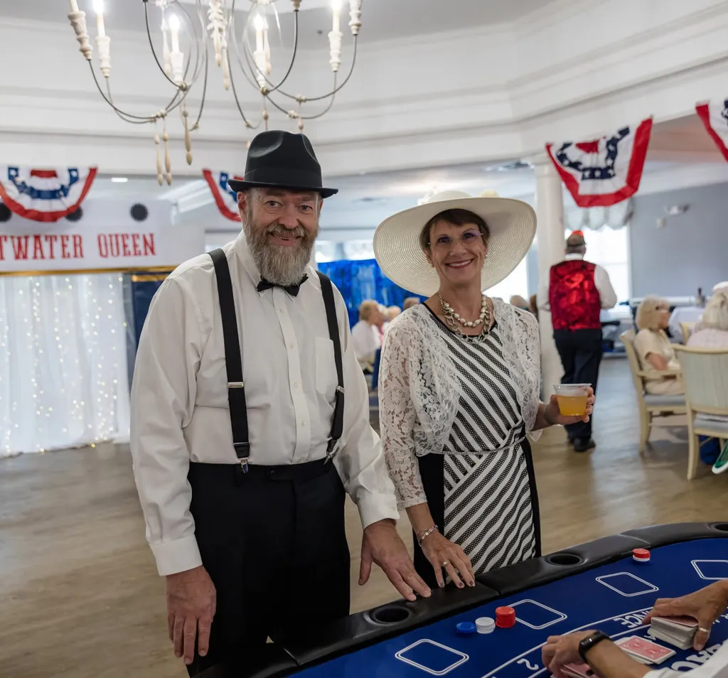 a well dressed couple at the blackjack table